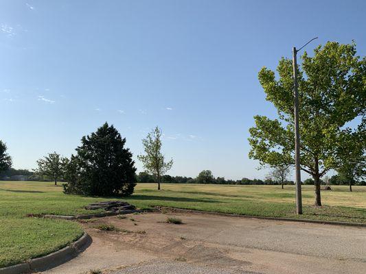 Parking area right next to grassy areas.