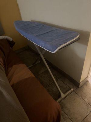 Ironing board open in middle of room