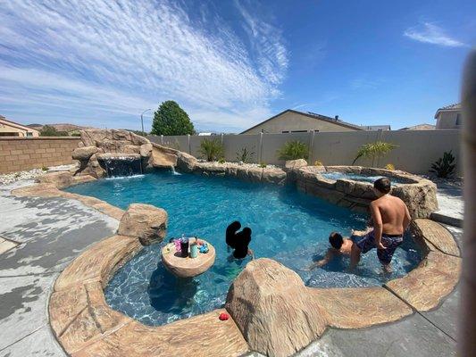 Family enjoying their sculpture rock pool in Murrieta.  Free estimate?