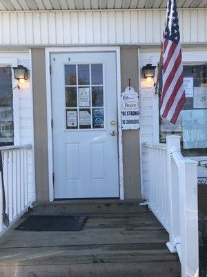 Front door.  Only a few people are inside at one time.  Others wait for someone to come out.