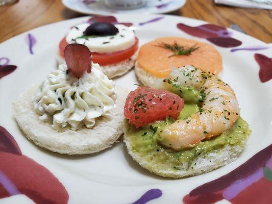 Tea sandwiches - angle #3: salmon, shrimp with avocado & grapefruit, goat cheese with grape, caprese