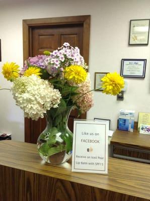 Welcome to our office. Dr. has a green thumb with his garden flowers.