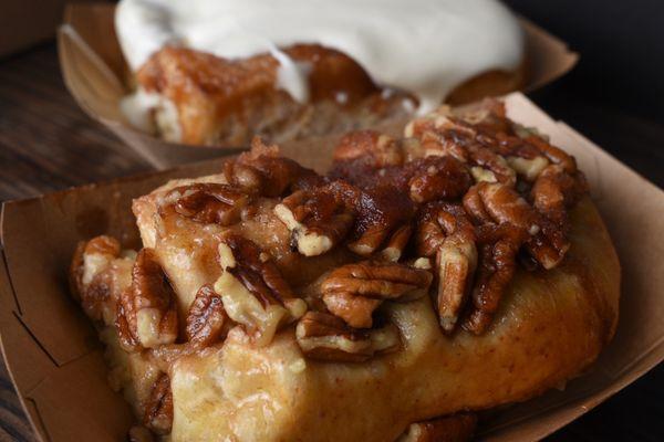 Pecan Cinnamon Roll (front) and Original Cinnamon Roll with Cream Cheese Frosting (back)