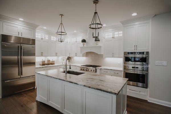 Custom Benjamin Moore Simply White painted cabinets from the Weber Cabinetry Group. Anderson Tuftex flooring.