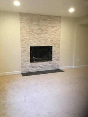 Basement build in fire place and wall to wall carpeting