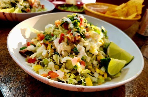 Steak Burrito Bowl - steak, black beans, corn, onions, pico,sour cream, salsa Verde, rice,lettuce, cilantro and limes