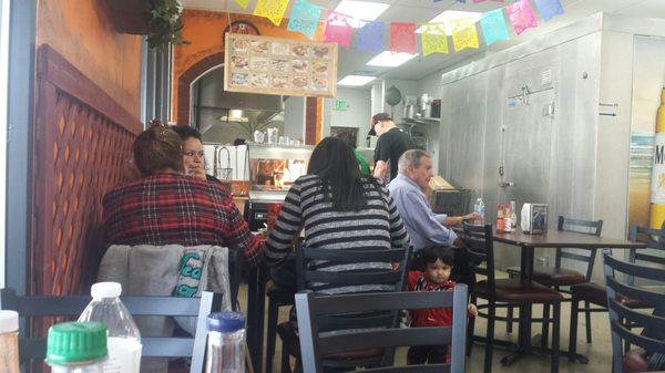 There are a number of tables for people to sit at while eating their meals.