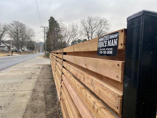 horizontal cedar fence on black posts