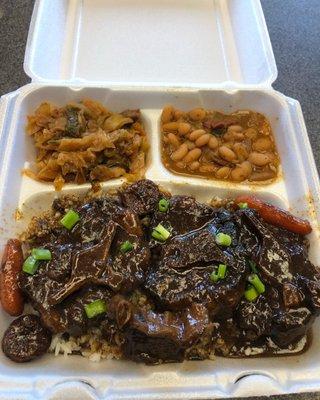 Smothered Ox Tails and beef short ribs and carrots. Two optional sides of the day. Such as, smothered cabbage and smoked sausage, white bean