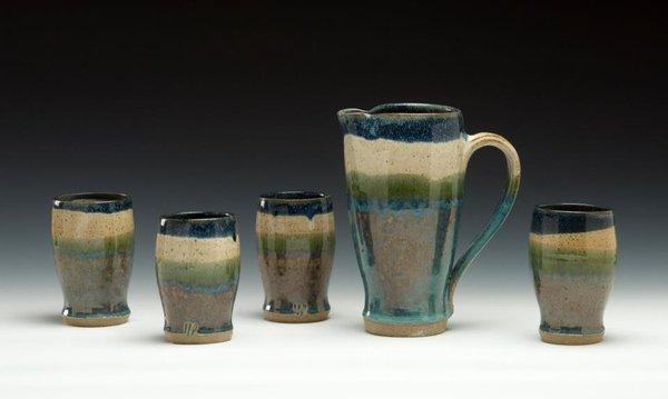 A tumbler and pitcher set.