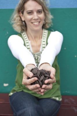 Hands full of chocolate waiting to be made into truffles.