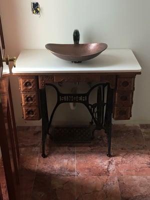 Sewing machine converted to bath vanity