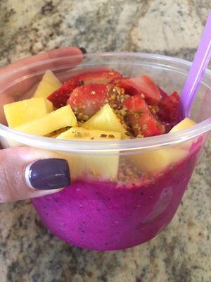 Pitaya bowl topped with mango, strawberry, bee pollen and granola