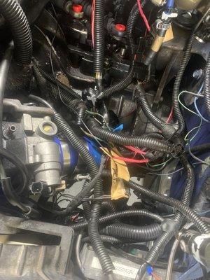 Wiring harness, everything looks like a rat nest and has to be gone through to move it out of the way of the shift cables