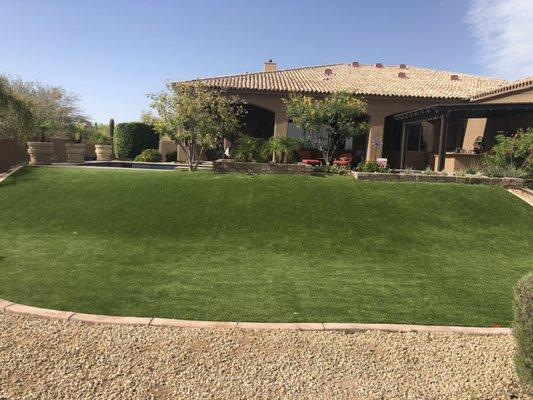 Beautiful turf on a difficult grade. Pergola over BBQ.