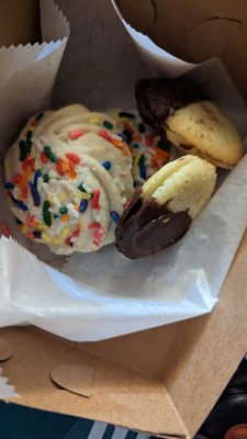 Half chocolate sandwich cookies and rainbow sprinkles cookies