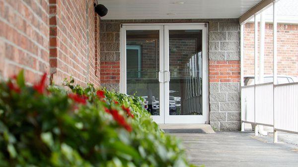 3 - The walkway from the parking lot to the lobby is lined with flowers.