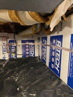 Crawl Space Insulation project with vapor barrier on the floor and rigid foam board insulation on the foundation walls