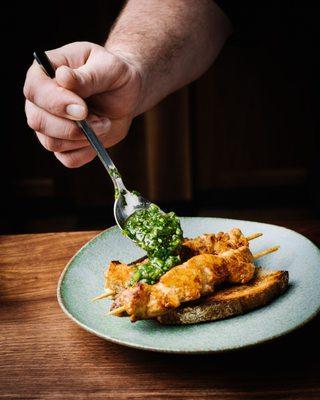 Marinated Chicken skewers with salsa verde and pickled shallots