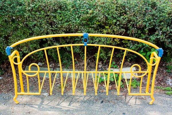 Just one of so many bike racks made from old metal head boards.