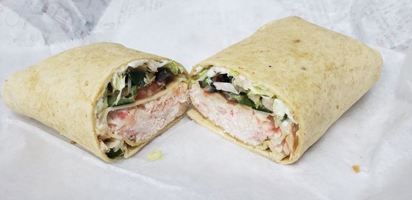 Seafood salad in sun-dried tomato wrap