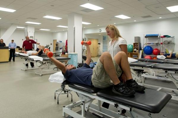 Ryan Center patients and staff in the main physical therapy room.