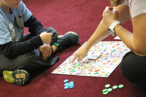 Playing games and having fun are apart of therapy. This child is working on his phonemic sound awareness.