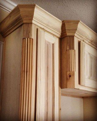 Poplar cabinets with raised panel doors, round mouldin on corners & crown