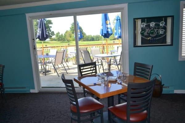 quieter dining area overlooking the outside patio dining area. Great scenery over the golf club and putting green