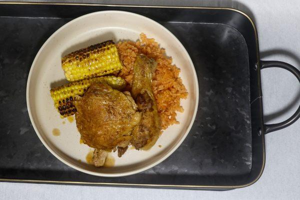 Mole braised chicken, red rice, and corn on the cob.