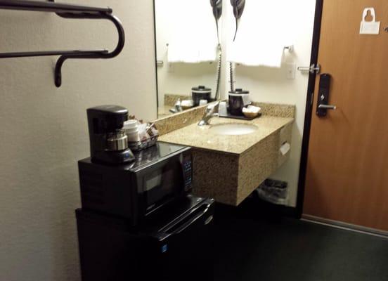 Mini-fridge, microwave, coffee maker, hair dryer and sink area