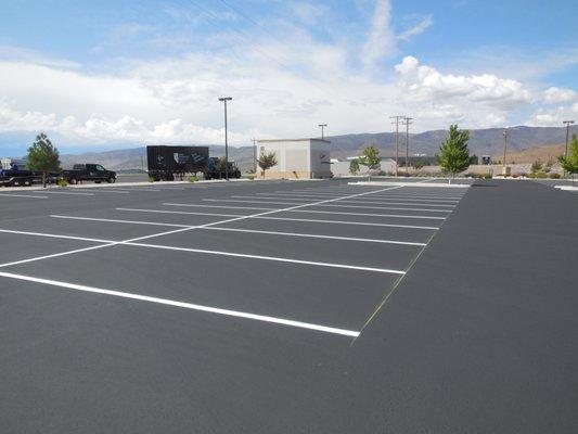 A large commercial parking lot, sealed and striped.