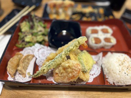 Lunch bento, tempura, spicy tuna roll and a hot night roll in the back