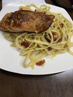 Salmon and fettuccine with sun dried tomatoes in olive oil and garlic!