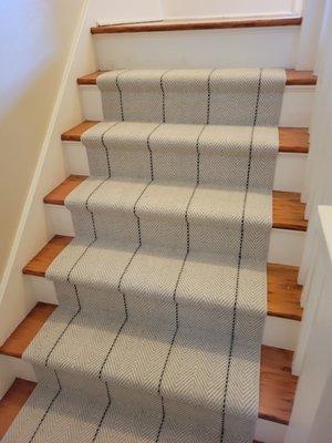 Custom-Pattern carpet runner installed on hardwood stairs