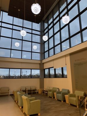 Downstairs, the elevators are on the left side of this waiting area at the first floor entrance.