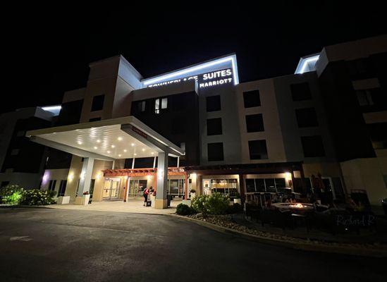 Entrance features a fire pit patio area and excellent lighting.