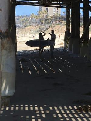 Surfers at Pacific Beach Pier