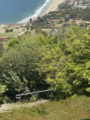 Newly installed galvanized railing in foreground with ocean in background