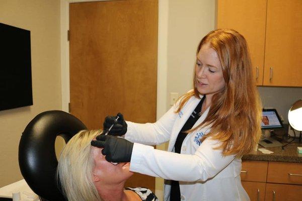 NP Brandy Prince injecting Botox to a patient's unwanted wrinkles.