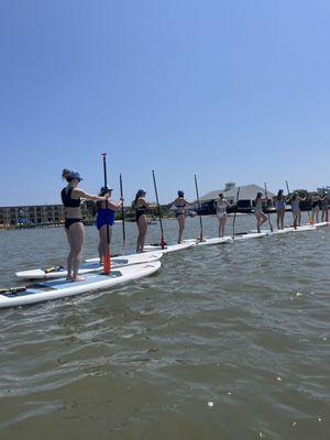 Group SUP Yoga safe and anchored on the bay.