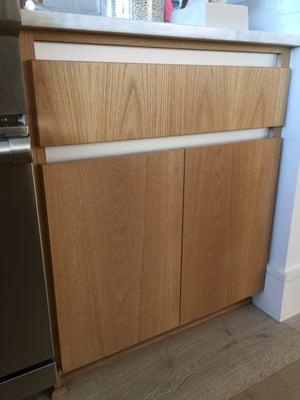 Our integrated hardware and clean lamented white oak kitchen cabinets.