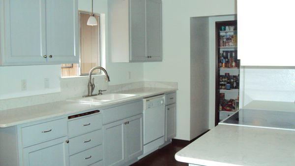 A soothing, grey galley kitchen.