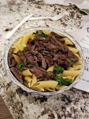 Steak and broccoli rabe with oil and garlic over penne