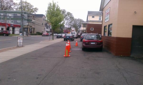 Park to the left of the traffic cones, stay in your car and someone will eventually come out and speak to you.