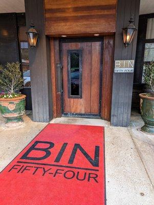 Exterior shot of Bin 54 Steak & Cellar, the steakhouse located at Glen-Lennox Shopping Center. I took this photo on March 28, 2023.