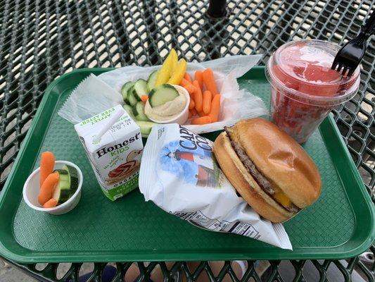 Kid's cheeseburger meal.  Basket of vegetable & humus dip.  Watermelon chunks.