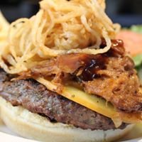 Texas Burger. Delicious half pound burger topped with our pulled pork, smoked gouda cheese, and fried onion strings