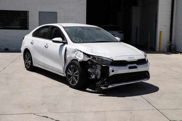 The vehicle received is a 2022 Kia Forte. The primary area of damage is located on the front right side of the vehicle.