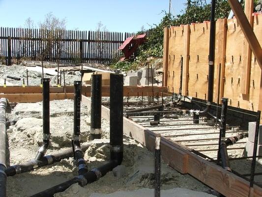 Custom bath rough plumbing, under-slab drains, installed by us.